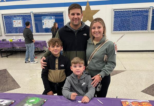 McAuliffe family pose proudly in commons at family reading night