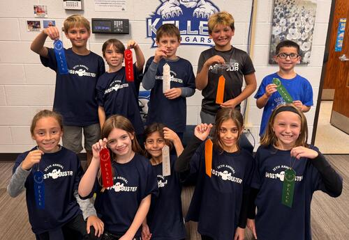 Top five boys and girls finishers pose proudly with ribbons