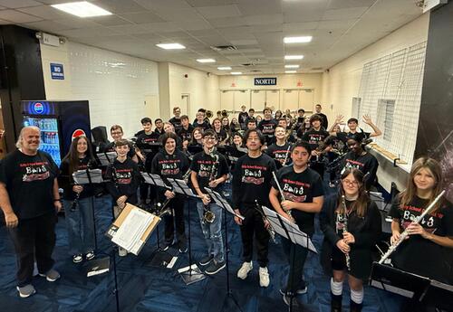 Symphonic Band poses proudly while playing at Chicago Wolves game