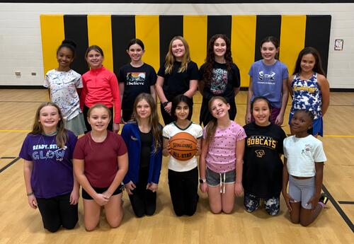 Bannes' fifth-grade girls' basketball team poses for picture in gym after practice