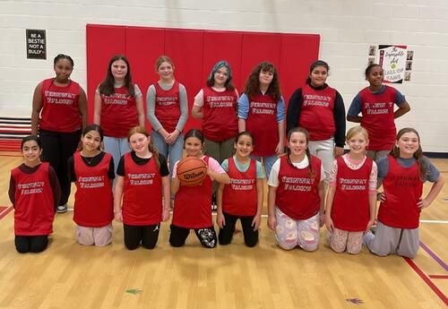Fernway fifth-grade girls' basketball team pose proudly in gym after practice