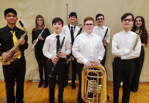 Eight band students pose proudly with the instruments at the Illinois Music Education Association (ILMEA) Band Festival