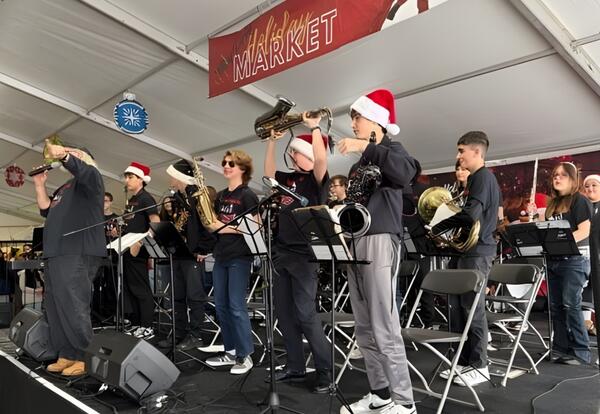 Jazz Ensemble smiles on stage at Tinley Park Holiday Market after performance