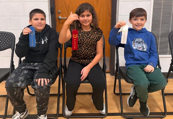 Top three Bannes Spelling Bee winners pose proudly with ribbons