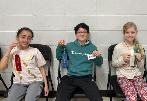 Top three Fernway Spelling Bee participants pose proudly with their ribbons