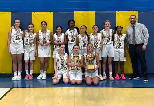 Prairie View's 6/7th grade girls' volleyball team pose proudly with coach, trophy and medals after winning SWIC Tournament
