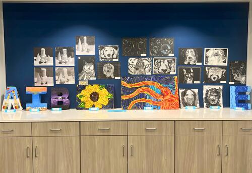 Grissom Middle Sschool students artwork on display in board room at Ad Center