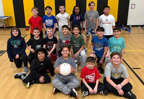 Bannes fifth-grade boys' volleyball team pose in school gym after practice