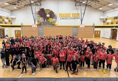 Breakthrough participants pose for a photo in front of a mural of an eagle and the words "Prairie View Eagle Country"