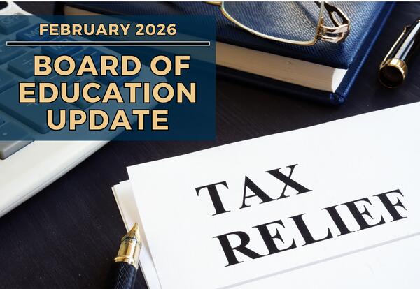 A calculator, a notebook with glasses and a pen, and a document titled TAX RELIEF are arranged on a dark surface.