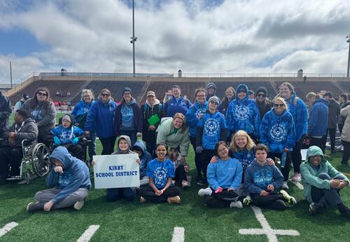 Students athletes and staff pose at track and field spring games