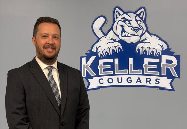Principal Alex Weinberg poses next to Helen Keller School Mascot