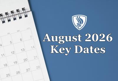 A spiral-bound calendar page showing numbers from 4 to 28 against a blue background with the KSD Flame logo and August 2026 Key Dates written underneath.