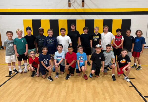 Bannes boys' basketball team pose proudly in school gym after practice