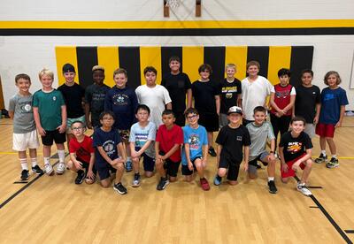 Bannes boys' basketball team pose proudly in school gym after practice