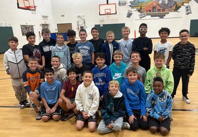 Millennium boy's basketball team pose for picture in school gym after practice