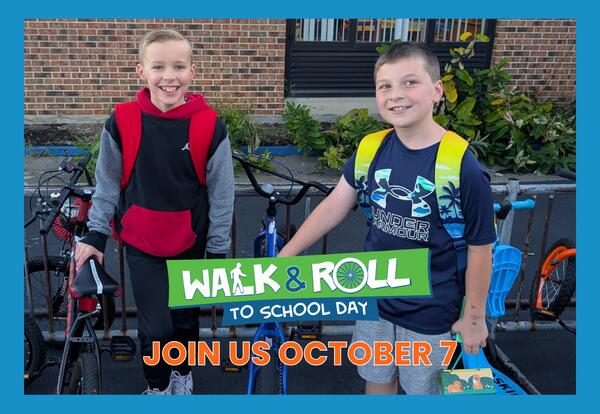 Walk & Roll to School Day - Join Us October 7 written with image of two students standing by bike rack outside with blue border