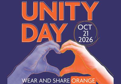 Purple background with Unity Day , Oct. 21 Wear and Share Orange written around two hand making a heart