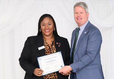 SGA Executive President Pamela Williams, recipient of the Gators Give Scholarship, with NTCC Chancellor Jim Carlson