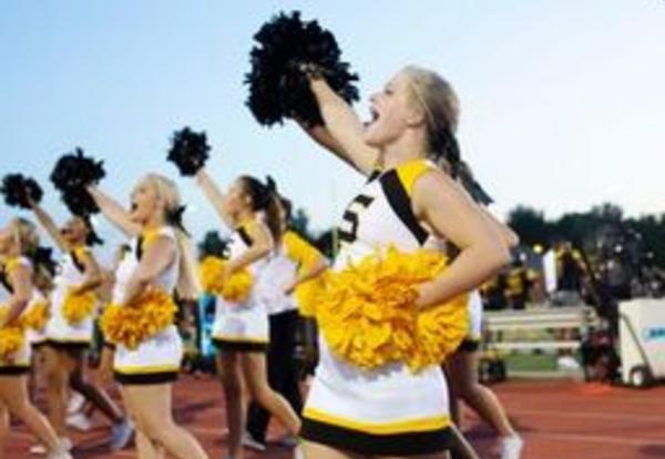 Cheerleaders cheering on sideline