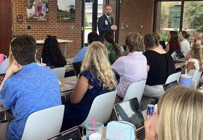 Partnership Middle School Principal, Joshua Yeager, leads a professional development session for teachers in training.
