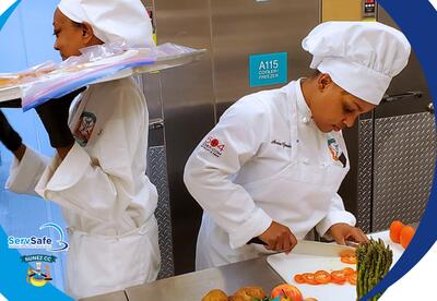 A Nunez Culinary student chops vegetables.