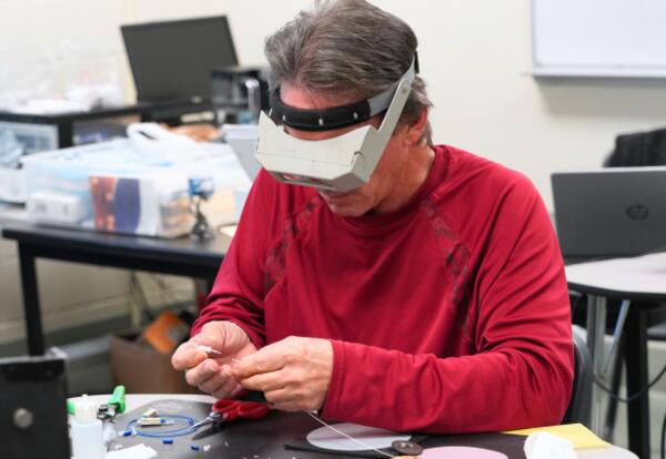 A Fiber Optics student in class at Nunez Community College.