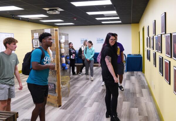 A Nunez instructor and students explore the Los Isleños Historical Archive in the Nunez Library.
