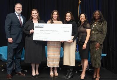 Dr. Tina Tinney, Nunez Chancellor, poses with an oversized check for a $54,000 donation with industry partners.