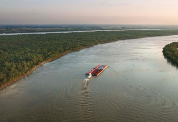 A shipping barge floats down the Mississippi River.