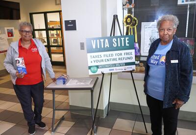 VITA tax preparers Gail Jenkins and Gwen Ricks are shown in front of the Nunez Library
