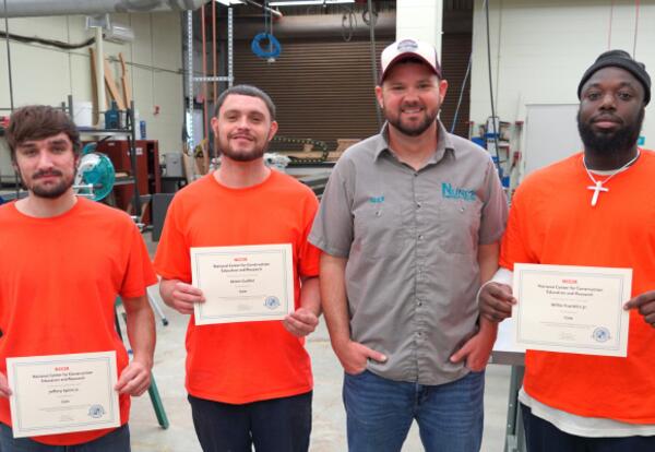 St. Bernard Parish Jail trusties show off their NCCER Core certificates with instructor Alex Mulvaney