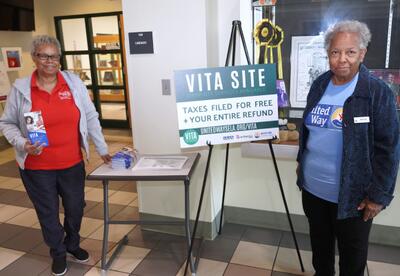 VITA tax preparers Gail Jenkins and Gwen Ricks are shown in front of the Nunez Library
