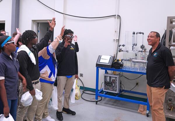 A Nunez instructor speaks to visiting high school students in the Process Technology lab.