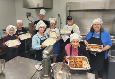 Leisure class participants show off their hand-made cinnamon rolls in the culinary program kitchen.