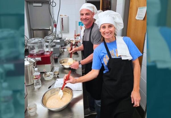 Leisure class participants show off their hand-made sauce in the Culinary Kitchen