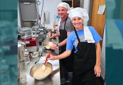 Leisure class participants show off their hand-made sauce in the Culinary Kitchen