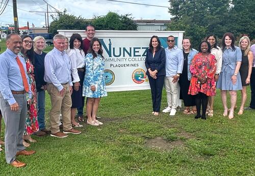 Nunez and Plaquemines Parish officials pose by the sign outside Nunez's new Plaquemines Parish site.