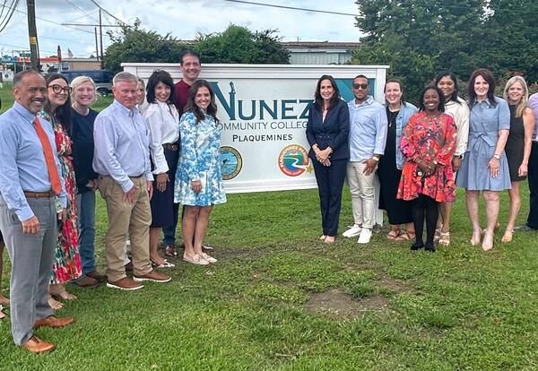 Nunez and Plaquemines Parish officials pose by the sign outside Nunez's new Plaquemines Parish site.