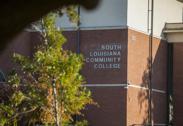 Brick building on South Louisiana Community College's Lafayette Campus  with green tree.