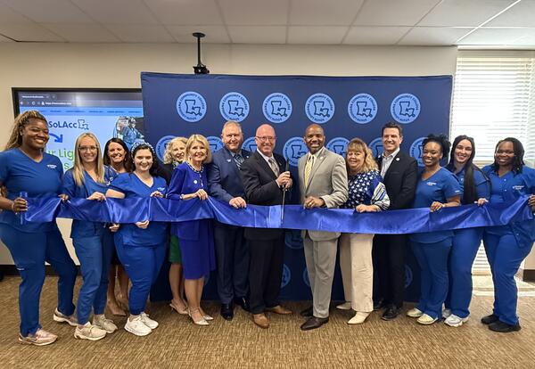 people cutting ribbon