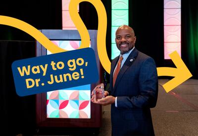 Vincent June holding award