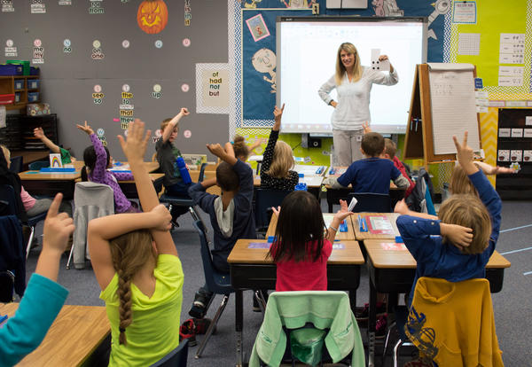 Teacher teaching class of children