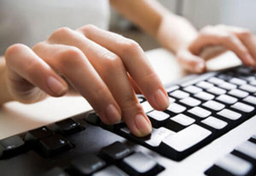 hands typing on keyboard
