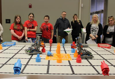Robots from two elementary school teams competing against each other
