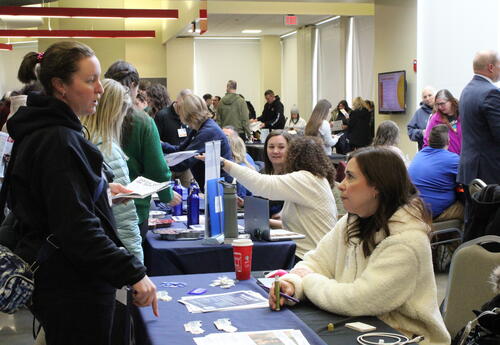 IU1 staff visits a vendor table during Wellness In-Service