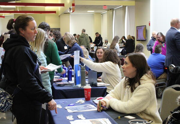 IU1 staff visits a vendor table during Wellness In-Service