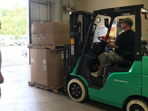 Staff driving a fork lift