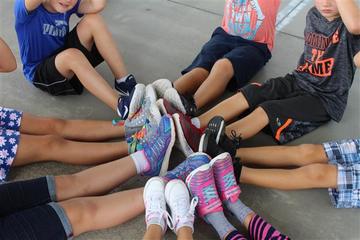 Closeup of girls' and boys' feet sitting in a circle