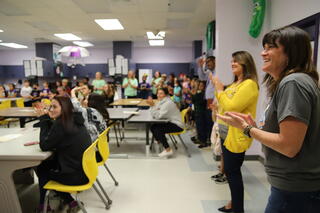 several students at tables in the cafeteria